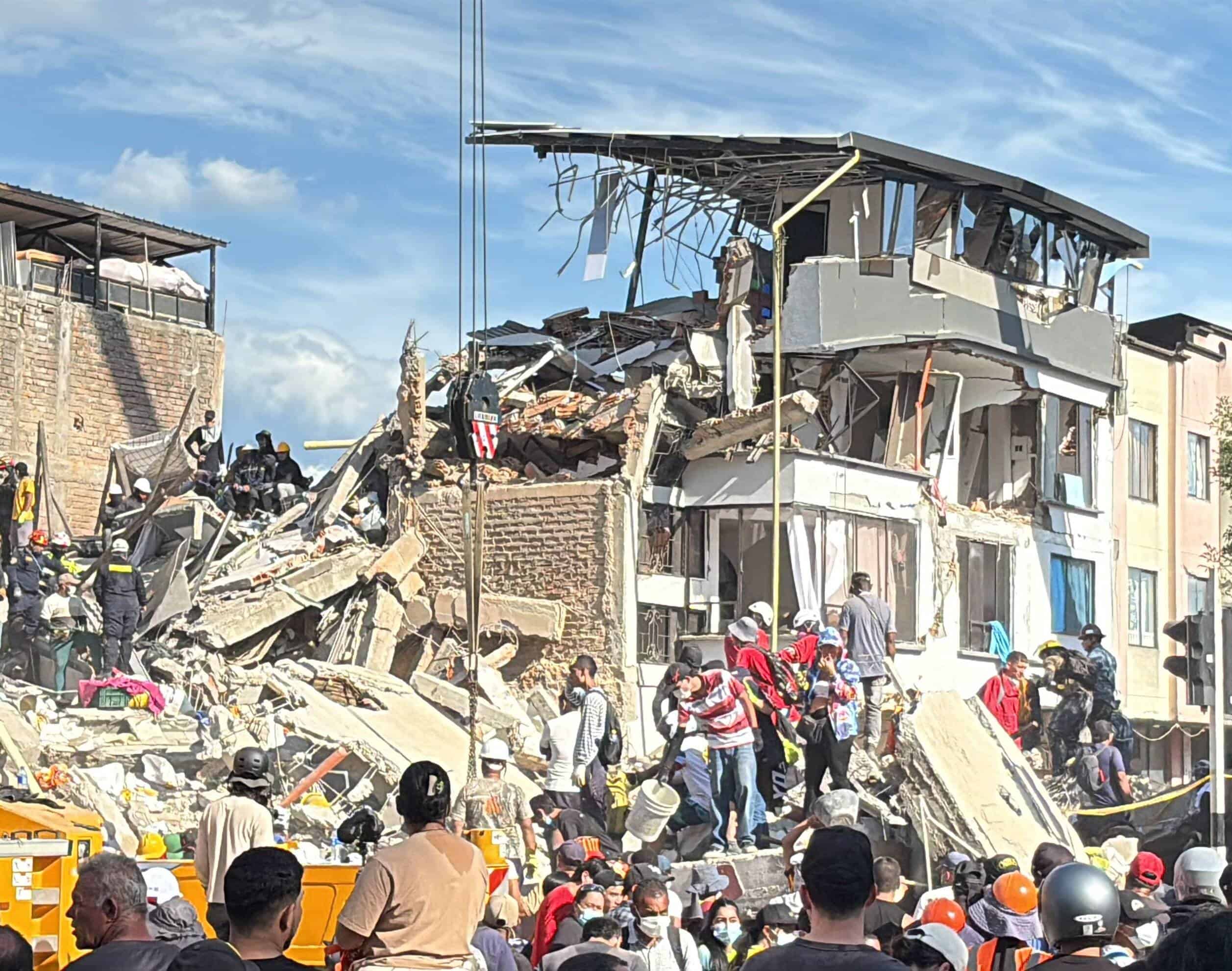 Pereira_after_the_earthquake_-_WCK_cropped - Africans Rising - Africans Rising Emergency responders search through a collapsed building rubble after a structural collapse, with debris and rescue equipment visible and a bright blue sky above.
