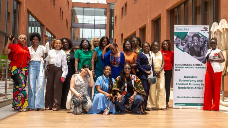 Group of diverse women posing for a outdoor group photo, with an Africans Rising banner in the background.