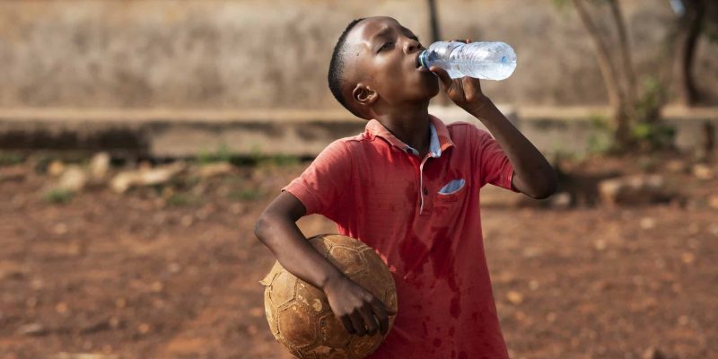 medium-shot-boy-drinking-water